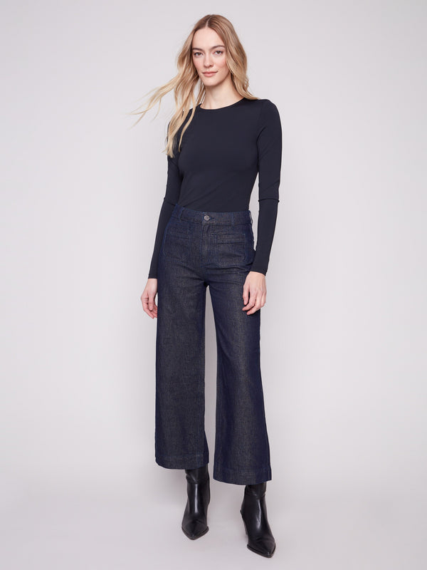 Blue black cropped jeans with a flare fit and subtle metallic finish, perfect for a chic look by Charlie B.