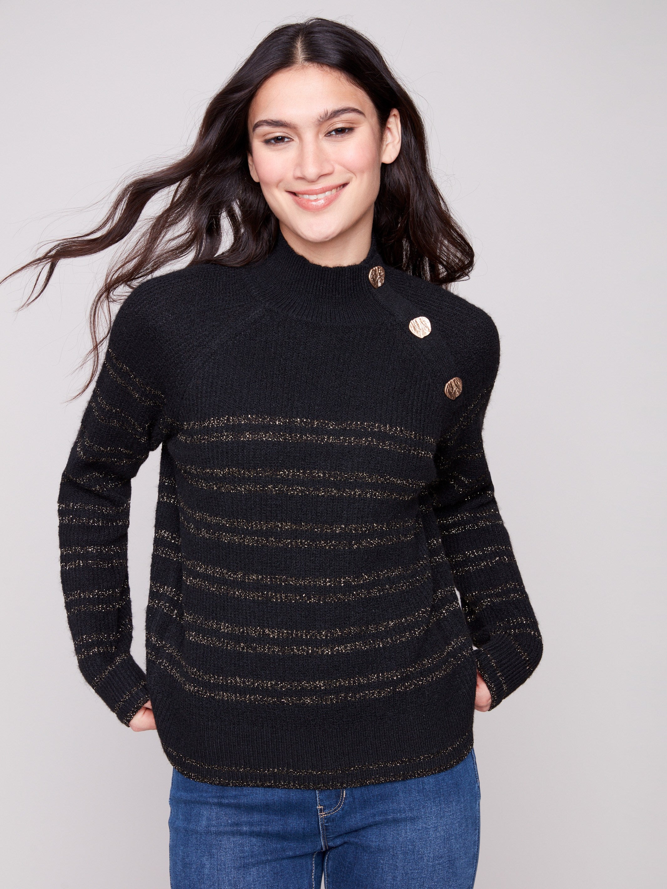 Black sweater with raglan sleeves featuring gold metallic stripes and button accents, offering a chic look by Charlie B.