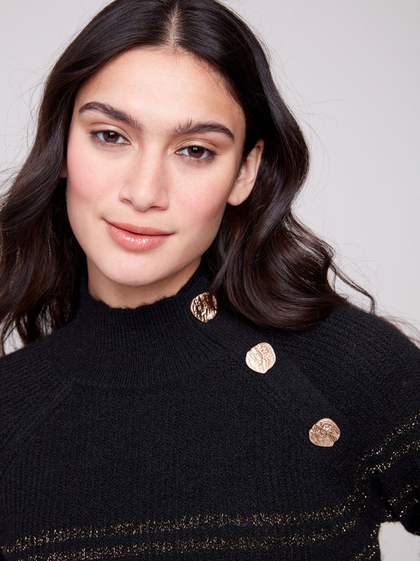 Sophisticated black sweater with a mock neck and eye-catching button details, accented with gold stripes by Charlie B.
