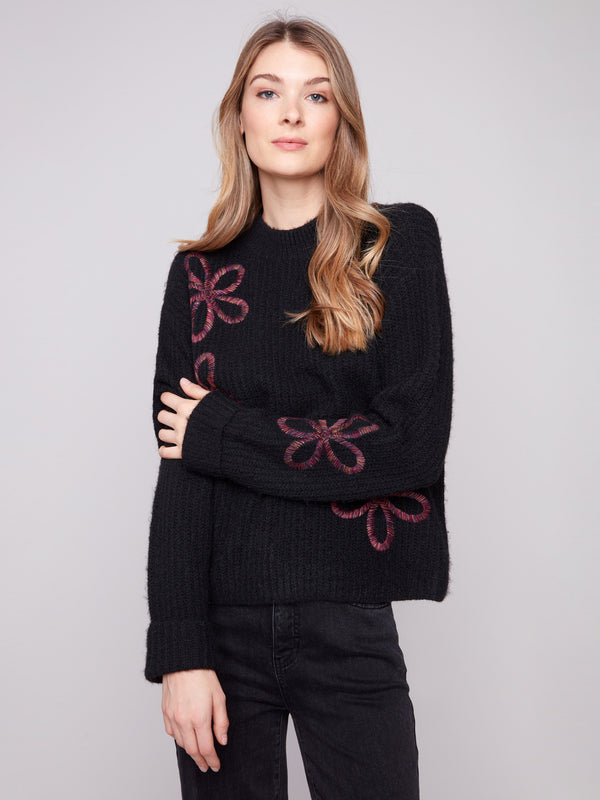 Black sweater with mock neck and elegant floral soutache, showcasing a relaxed fit by Charlie B.