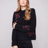 Black sweater with mock neck and elegant floral soutache, showcasing a relaxed fit by Charlie B.