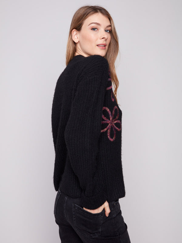 Stylish black sweater with relaxed fit and detailed floral soutache accents by Charlie B.