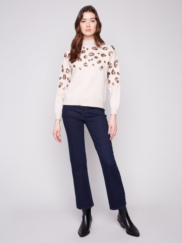 Long sleeves offer comfort and style in this beautifully detailed sequin sweater by Charlie B.