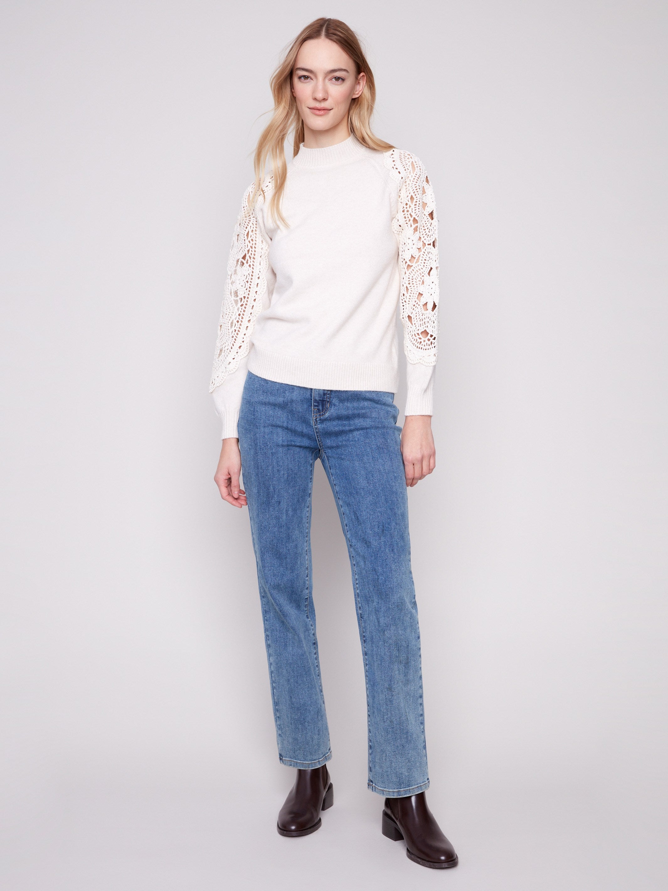 Stylish ecru sweater with crochet sleeves, adding a touch of elegance and texture to your outfit by Charlie B.