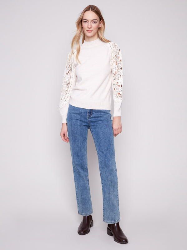 Stylish ecru sweater with crochet sleeves, adding a touch of elegance and texture to your outfit by Charlie B.