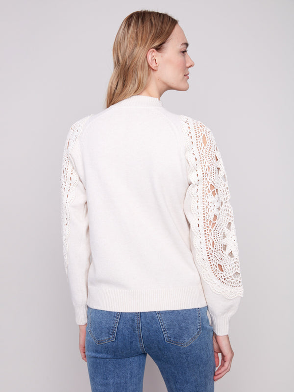 Elegant ecru sweater showcasing ribbed cuffs for a comfortable and snug fit, ideal for cool weather wear by Charlie B.