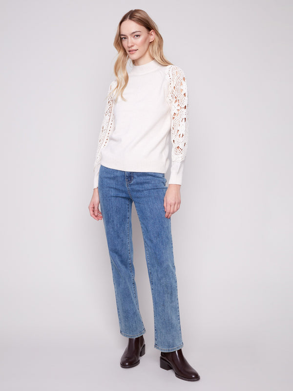 Chic ecru sweater with intricate crochet detailing on the sleeves, offering a unique and fashionable look by Charlie B.