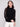 Elegant black sweater featuring a mock neck design, paired with delicate crochet detailing for a sophisticated look by Charlie B.