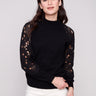 Elegant black sweater featuring a mock neck design, paired with delicate crochet detailing for a sophisticated look by Charlie B.