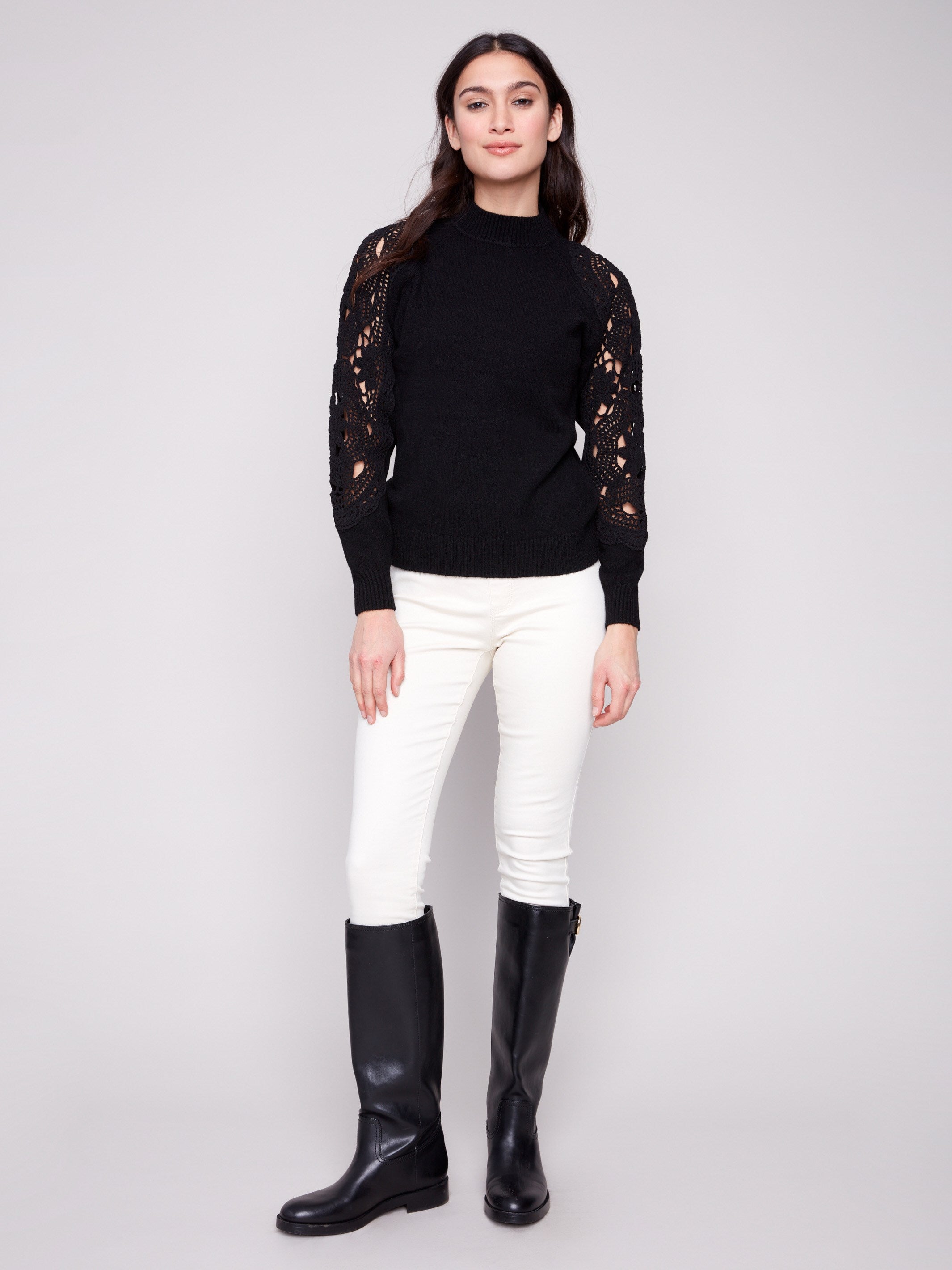 Stylish black sweater with exquisite crochet sleeves, complete with ribbed cuffs adding a touch of elegance by Charlie B.