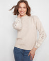 Almond sweater featuring elegant floral embroidery on the sleeves, crafted from soft fabric with a mock neck by Charlie B.