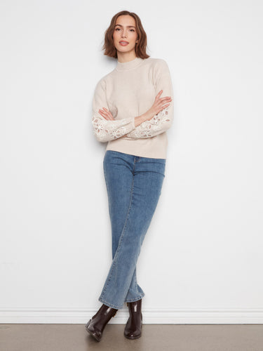 Soft almond sweater with drop shoulders and delicate floral embroidery, perfect for cozy elegance by Charlie B.