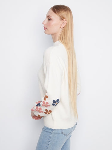 The sweater's ribbed cuffs and hem provide a snug fit while showcasing beautiful sleeve embroidery for style by Charlie B.