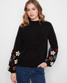 Black sweater featuring long balloon sleeves with colorful floral embroidery by Charlie B.