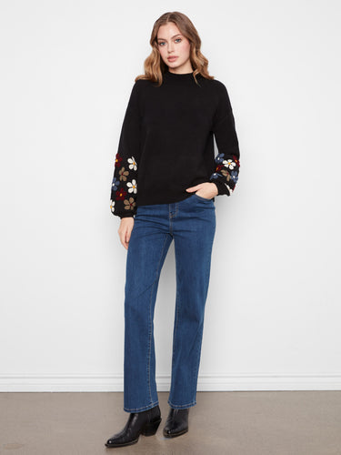 Ecru sweater showcasing ribbed cuffs and hem with vibrant floral sleeve details by Charlie B.