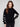 Chic black sweater with a mock neck and charming white hearts, showcasing a stylish drop shoulder design by Charlie B.