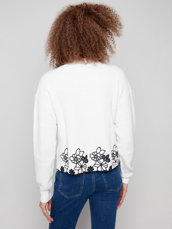 Classic ecru mock neck sweater featuring detailed black floral lace hem to enhance your wardrobe effortlessly by Charlie B.