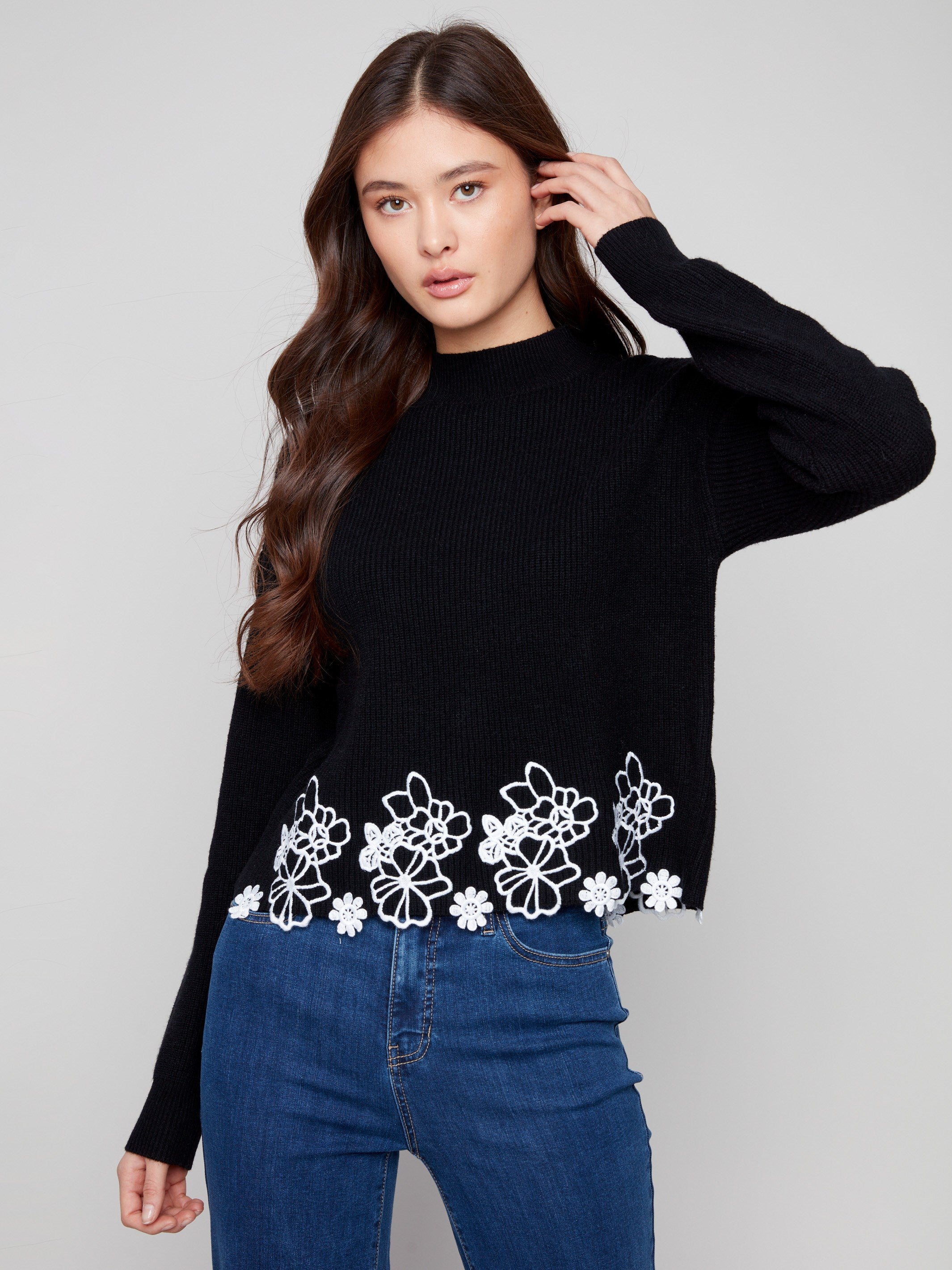 Elegant black sweater with exquisite floral lace hem and mock neck, ideal for a sophisticated look by Charlie B.