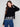 Elegant black sweater with exquisite floral lace hem and mock neck, ideal for a sophisticated look by Charlie B.