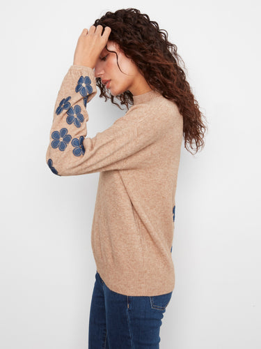This chic sweater showcases beautiful floral patches on the sleeves, perfect for a trendy look. By Charlie B.