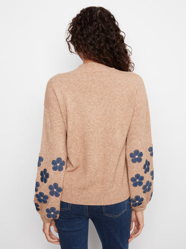 Mock neck sweater designed with charming floral accents on the sleeves for added visual interest. By Charlie B.