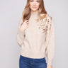 Elegant sweater with mock neck and intricate floral embroidery, adding a touch of sophistication by Charlie B.