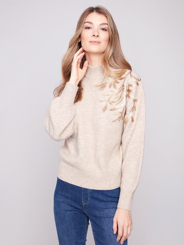Mock neck and delicate floral accents make this sweater a versatile wardrobe staple by Charlie B.