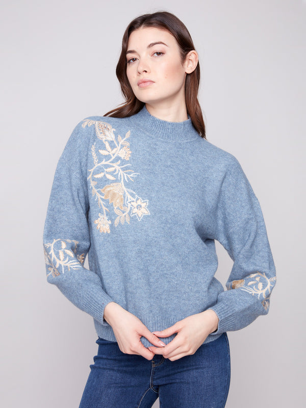 Chic sweater in heather denim, emphasized by beautiful floral embroidery and sequins for added flair by Charlie B.