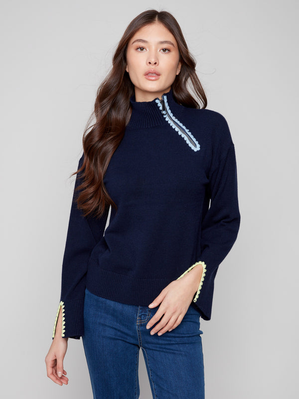Navy sweater featuring a mock neck and unique open sleeve cuffs, adding a stylish touch to any outfit by Charlie B.