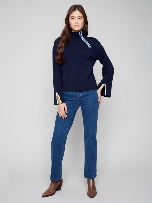 Elegant navy sweater with contrast crochet detail enhances the chic look, perfect for casual wear by Charlie B.