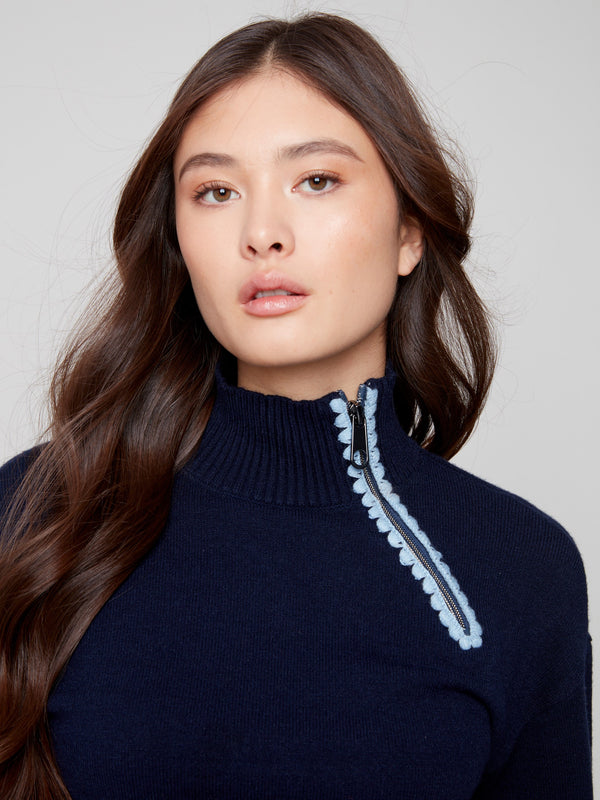 Stylish navy piece featuring crochet details along the zipper creates a fashionable statement by Charlie B.