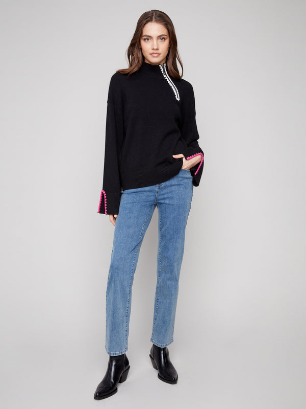 Sophisticated black sweater with open sleeve cuffs adding a touch of flair by Charlie B.