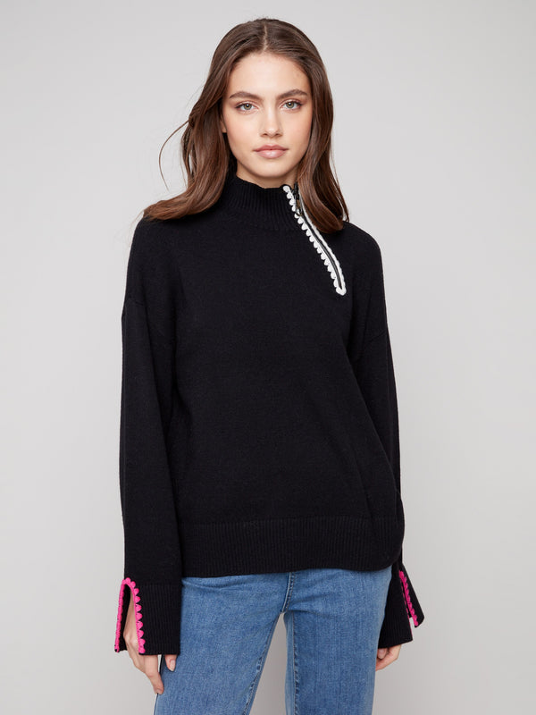 Trendy black sweater designed with open sleeve cuffs and a sleek mock neckline by Charlie B.