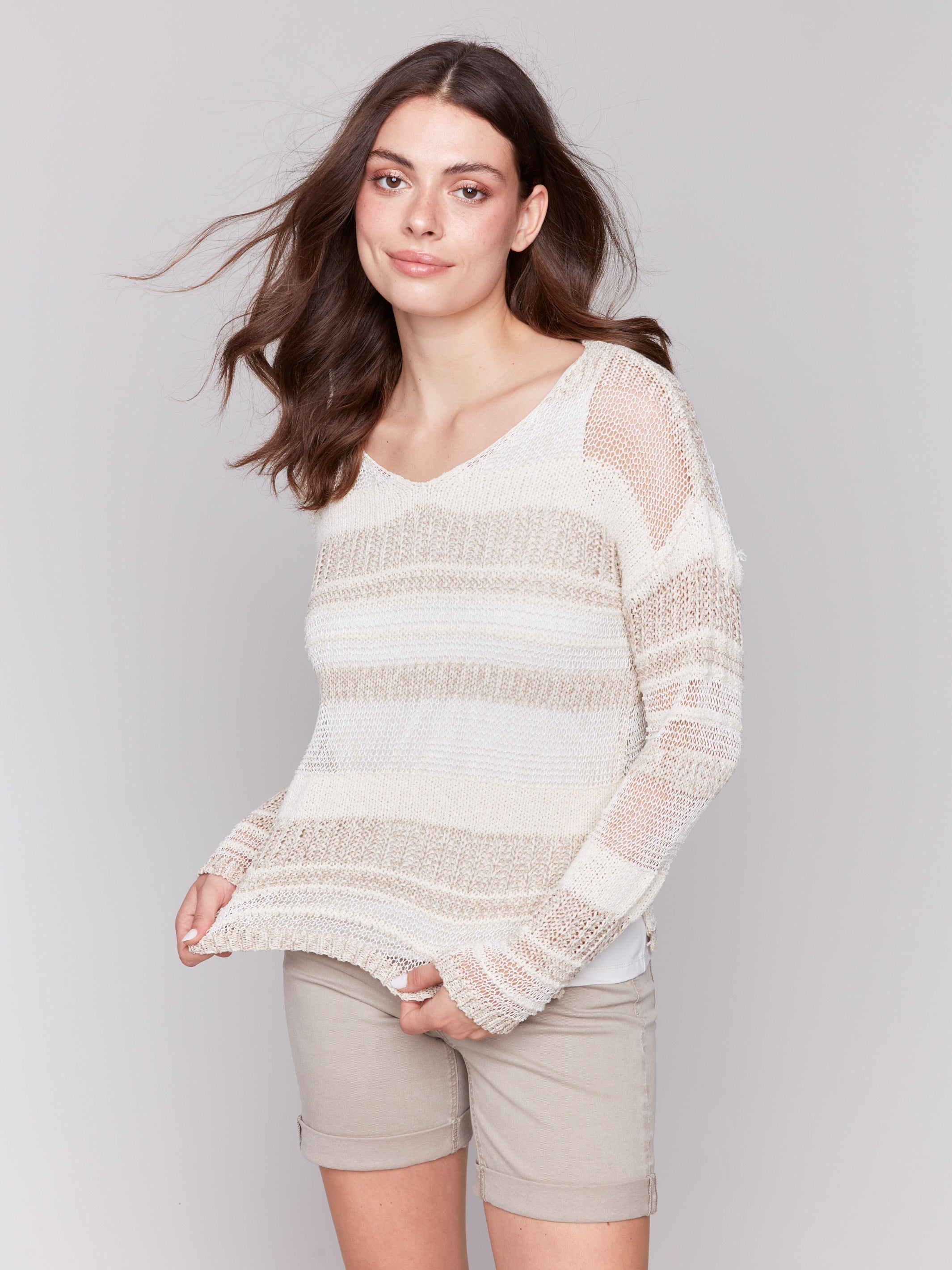 Cozy beige sweater designed with long sleeves for warmth and style by Charlie B.