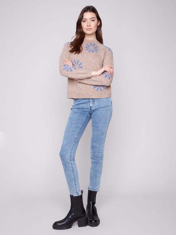 Fashionable heather nutmeg sweater with a crew neckline, highlighted by vibrant blue floral patterns by Charlie B.