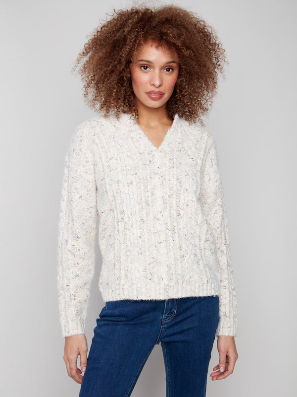 Ecru cable knit sweater with a notched neckline and drop shoulder design, perfect for a cozy look by Charlie B.