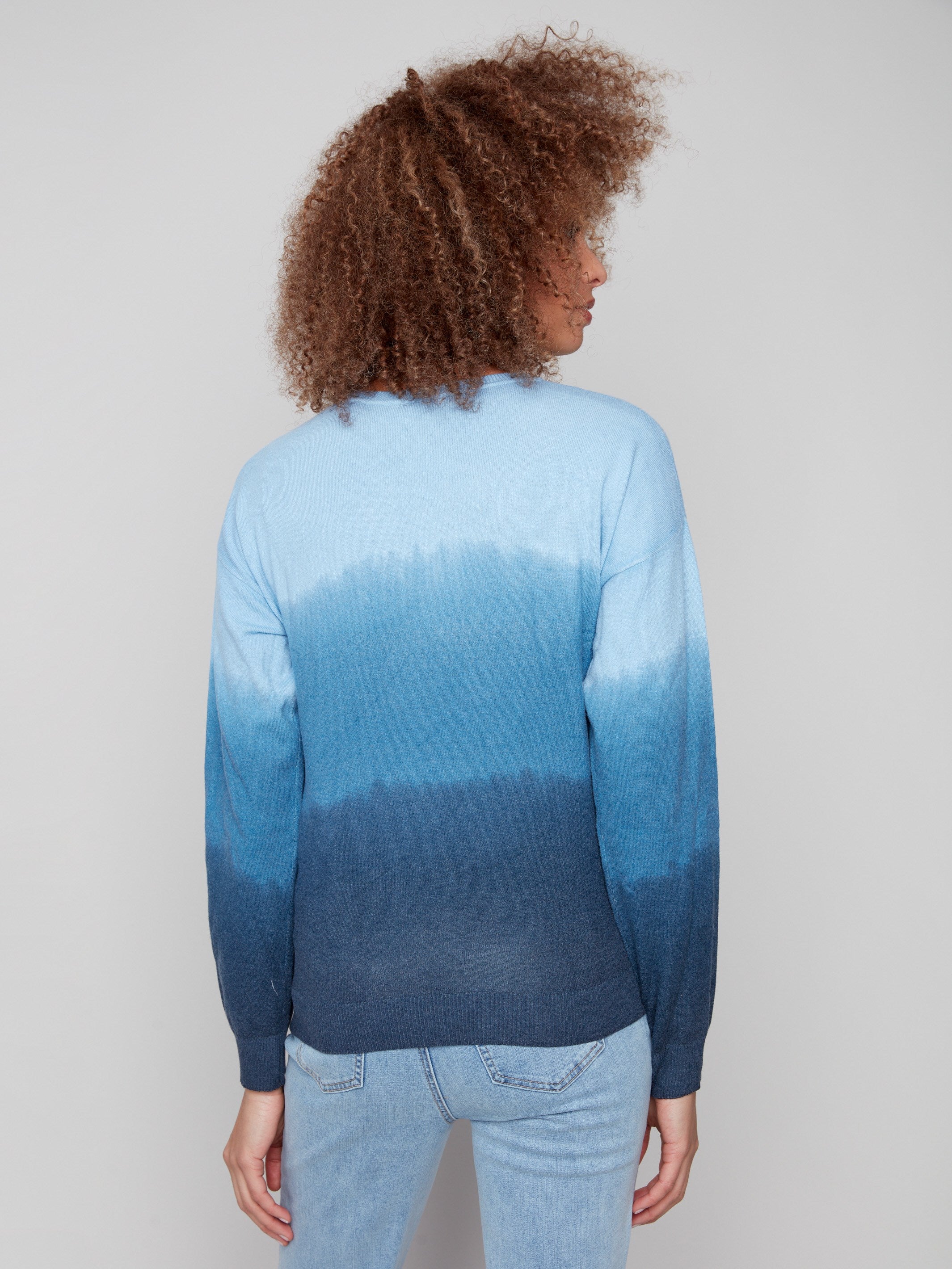 Stylish blue ombre sweater with knit cuffs, offering a cozy feel and artistic gradient for cooler days by Charlie B.