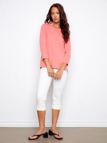 Comfortable coral top emphasizing simplicity and style, perfect for pairing with any wardrobe staple like these white pants. By Charlie B.