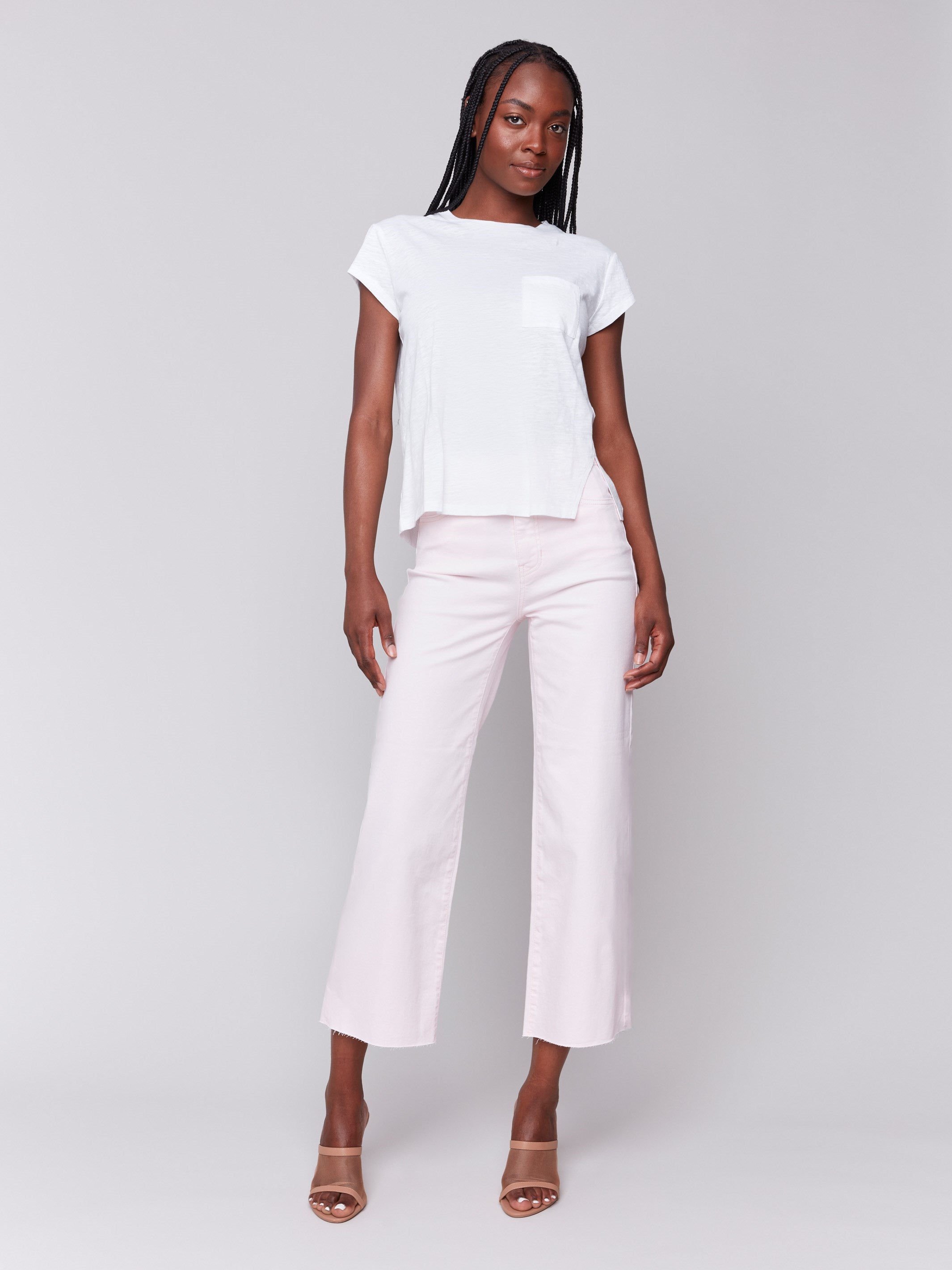 White tee featuring a chest pocket and short sleeves by Charlie B.
