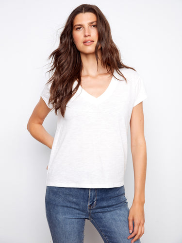 This white T-shirt with a drop shoulder and V-neck offers a relaxed fit for any occasion by Charlie B.