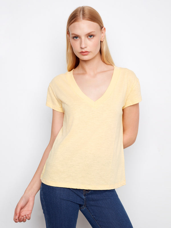 Yellow T-shirt featuring a stylish V-neck, perfect for casual outings. Crafted from lightweight cotton for all-day comfort. By Charlie B.