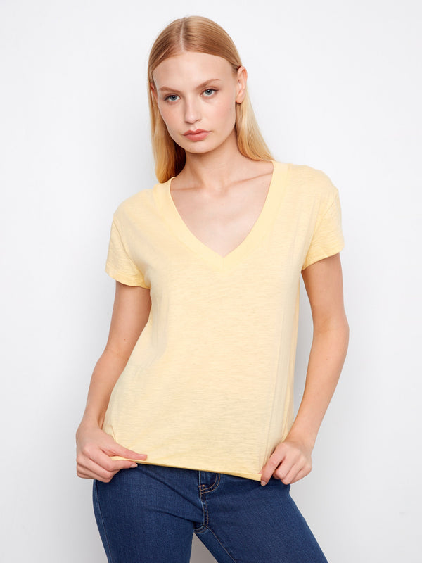 Lightweight cotton fabric ensures breathability in this chic yellow T-shirt, ideal for warm weather days. By Charlie B.