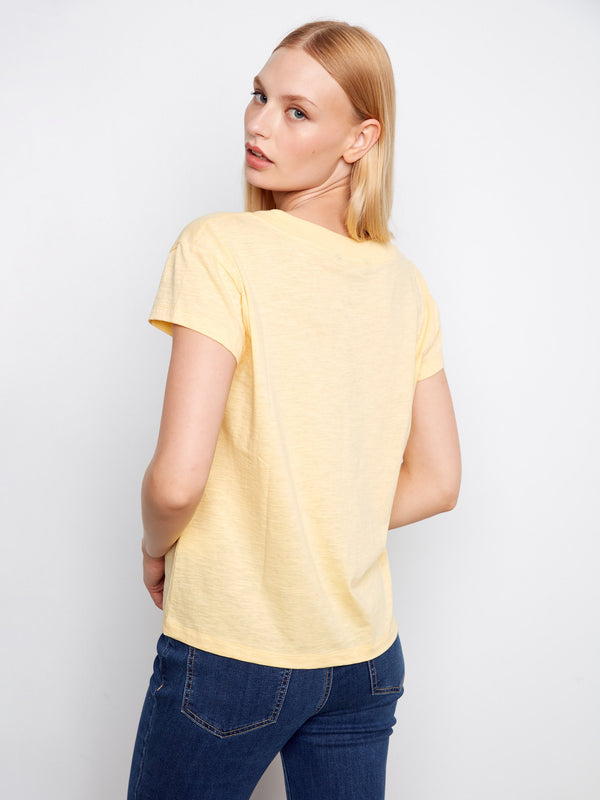 The V-neck style of this yellow T-shirt adds a touch of elegance to any casual look while keeping it simple and versatile. By Charlie B.