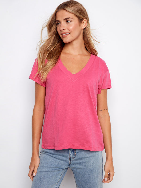Pink T-shirt featuring a flattering V-neck, perfect for casual outings. Ideal for layering or wearing alone. By Charlie B.