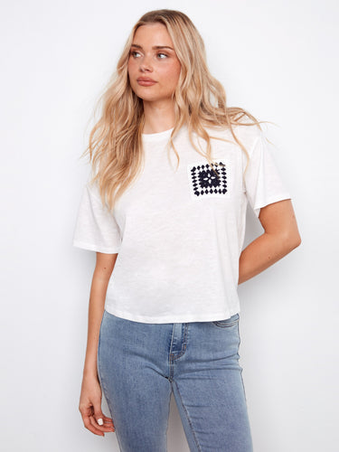 Elegant white t-shirt in breathable organic cotton with unique crochet accent by Charlie B.