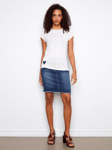The short sleeves on this white top offer comfort and style, making it ideal for warm days. Designed by Charlie B.
