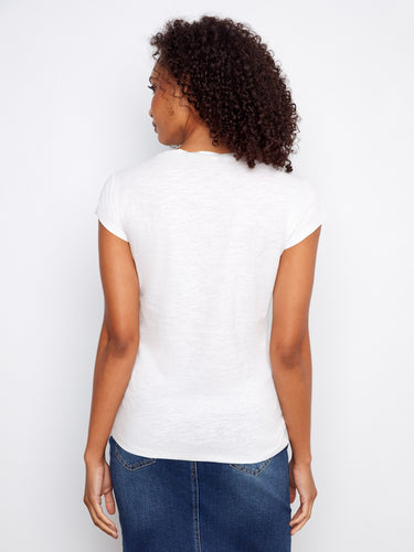 A chic addition to any outfit, this white tee boasts a classic crew neckline with modern flair. Styled by Charlie B.