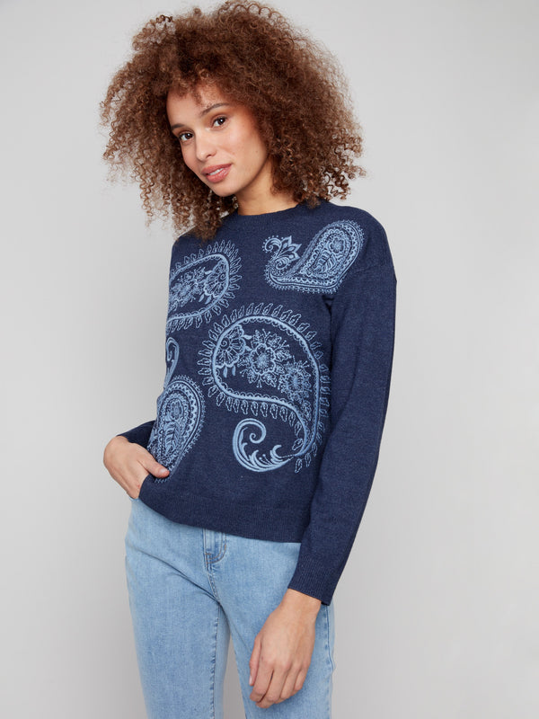 Comfortable heather denim sweater showcasing ribbed cuffs and intricate patterns by Charlie B.