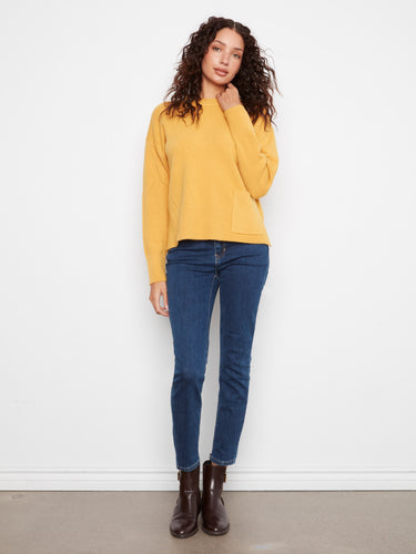 Casual elegance is achieved with drop shoulders and ribbed details on this versatile piece. By Charlie B.