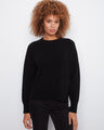 Black long-sleeve sweater featuring a stylish crew neck and elegant side slits by Charlie B.